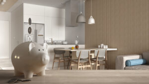 Wooden table top or shelf with white piggy bank with coins, modern white kitchen and dining room