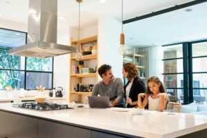 Happy family sits at newly refinished kitchen island